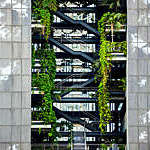 Vegetation grows out of the different levels of a plant-covered building in Barcelona, Spain.