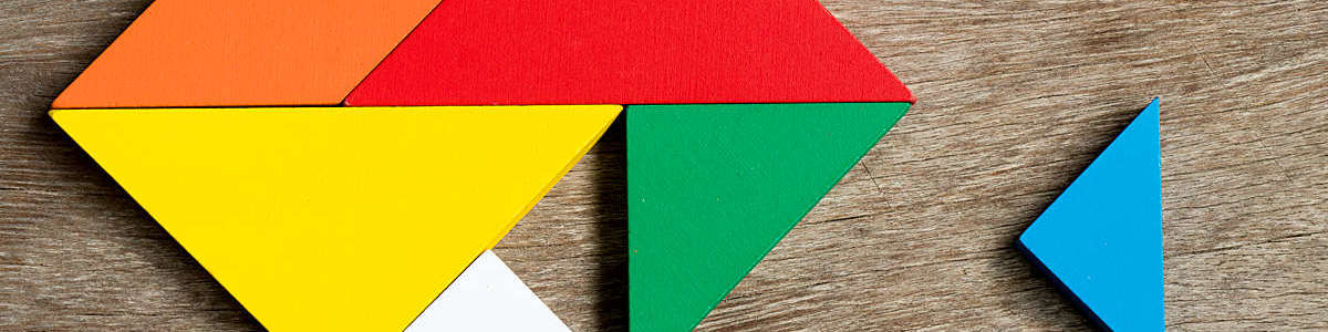 Colorful tangram puzzle in heart shape wait to fulfill on wood background (Concept of happy family, love fulfillment)