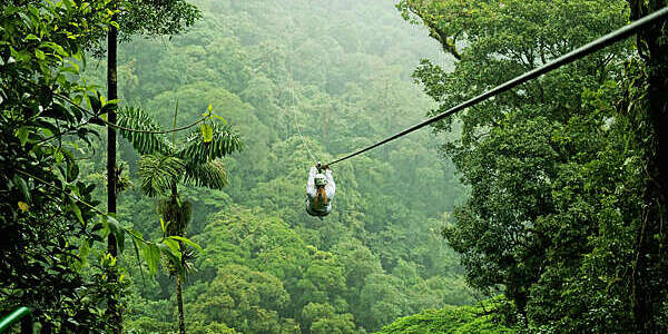 A person zip lining above a forest in Costa Rica.